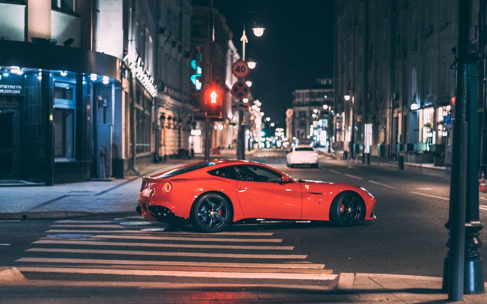 red ferrari 458 italia on road during night time