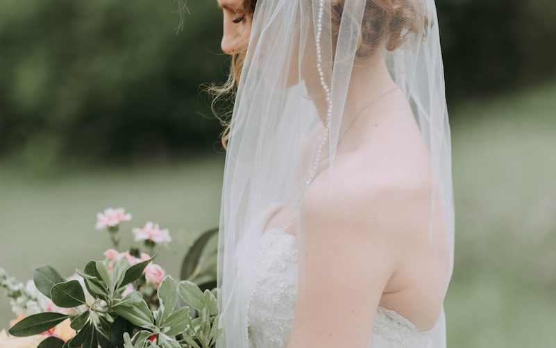 woman wearing white wedding dress with veil