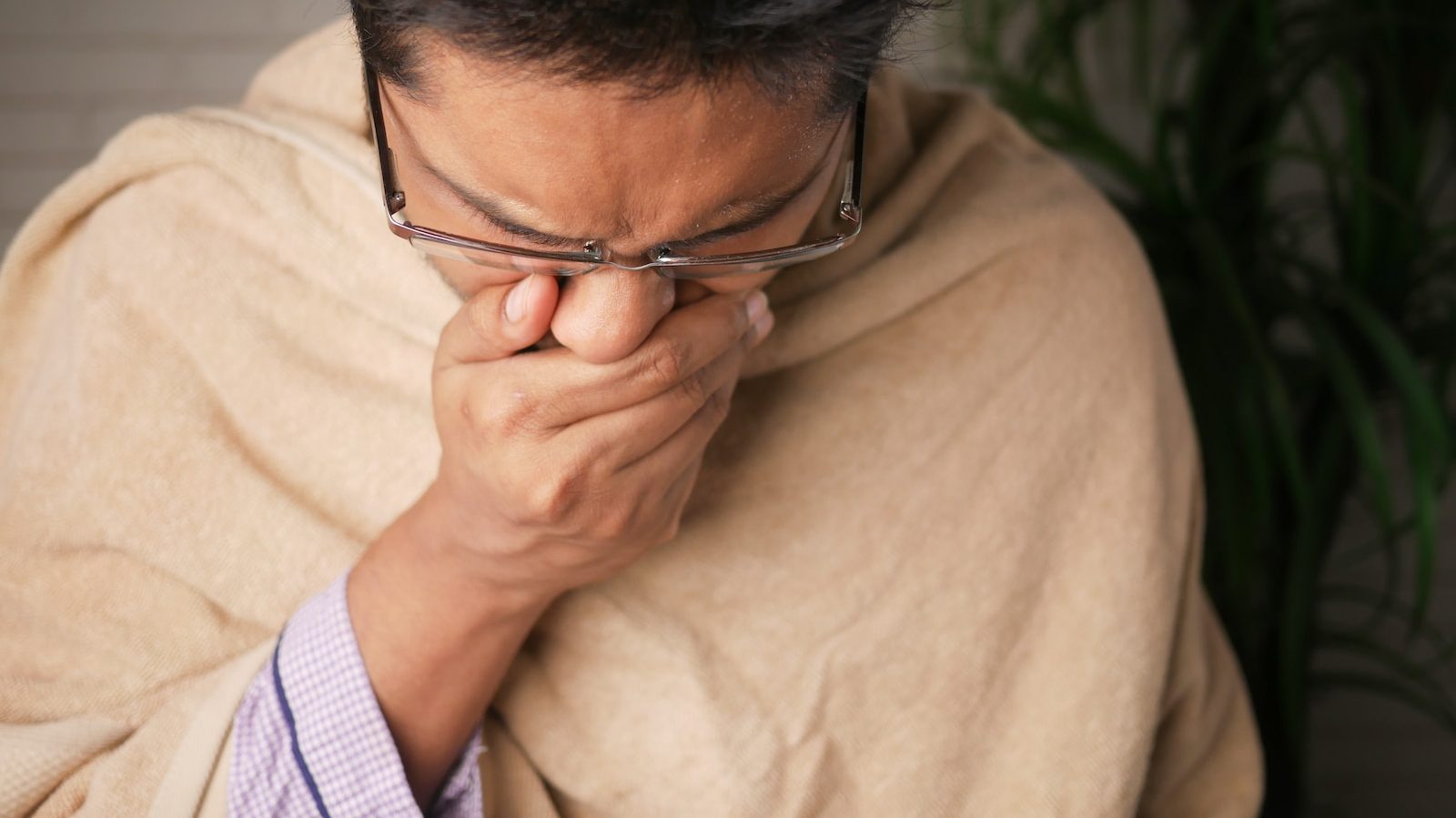 man in brown sweater wearing black framed eyeglasses