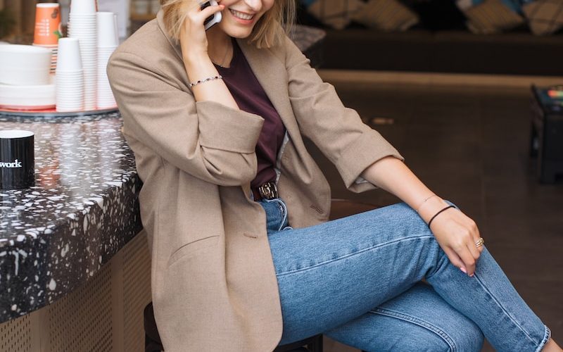 woman in blue denim jeans sitting on black metal seat