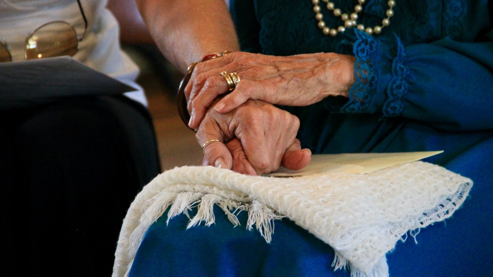 person wearing gold ring and blue dress